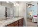 Bathroom vanity with double sinks, granite countertop, and door to bedroom at 416 Battlefield Creek Dr, Marietta, GA 30064