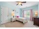 Bright bedroom with light blue walls, a ceiling fan, and a window with pink curtains at 416 Battlefield Creek Dr, Marietta, GA 30064