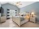 Bedroom with blue accent wall, ceiling fan, and window with striped curtains at 416 Battlefield Creek Dr, Marietta, GA 30064