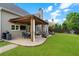 Charming covered patio with stone flooring, perfect for entertaining, featuring a grill and outdoor seating area at 416 Battlefield Creek Dr, Marietta, GA 30064