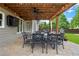 Elegant covered patio featuring a ceiling fan, outdoor television, and a dining set for comfortable outdoor living at 416 Battlefield Creek Dr, Marietta, GA 30064