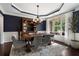Formal dining room with navy accent wall, decorative lighting and seating for six at 416 Battlefield Creek Dr, Marietta, GA 30064