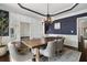 Dining room with dark blue walls, statement lighting, seating for six and hardwood floors at 416 Battlefield Creek Dr, Marietta, GA 30064