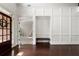 Beautiful foyer with dark wood floors, a bench, and striking white wainscoting at 416 Battlefield Creek Dr, Marietta, GA 30064