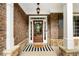 Inviting front porch with brick accents, charming decor, and a welcoming entrance at 416 Battlefield Creek Dr, Marietta, GA 30064