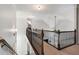 Upstairs hallway with wood and iron railing, neutral carpet, and decorative lighting at 416 Battlefield Creek Dr, Marietta, GA 30064