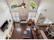 Bright living room with hardwood floors, large windows, and a stone fireplace at 416 Battlefield Creek Dr, Marietta, GA 30064