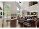 Inviting living room featuring a stone fireplace, soaring ceilings, and a comfortable leather sofa at 416 Battlefield Creek Dr, Marietta, GA 30064