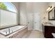 Bright bathroom with large arched window above the soaking tub at 416 Battlefield Creek Dr, Marietta, GA 30064