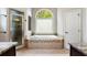 Elegant main bathroom with large tub and glass shower enclosure at 416 Battlefield Creek Dr, Marietta, GA 30064