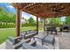 Cozy outdoor patio with pergola, dining area, and lush green backyard at 416 Battlefield Creek Dr, Marietta, GA 30064