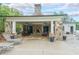 Stone patio with fireplace, seating, lounge chairs, and ceiling fans perfect for entertaining at 416 Battlefield Creek Dr, Marietta, GA 30064