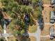 An aerial view of the property with a charming house surrounded by lush trees and a well-maintained lawn at 4347 Pleasant Ridge Rd, Decatur, GA 30034