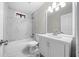 Bathroom featuring marble tile, white cabinets, and a tub/shower combination at 4347 Pleasant Ridge Rd, Decatur, GA 30034