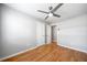 Bright bedroom featuring hardwood floors, ceiling fan, and white doors at 4347 Pleasant Ridge Rd, Decatur, GA 30034