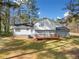 View of back exterior showing a home featuring a wooden deck, brick foundation, and white siding at 4347 Pleasant Ridge Rd, Decatur, GA 30034