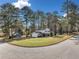 Corner lot with a view of a two-story home and attached garage surrounded by mature trees and landscaping at 4347 Pleasant Ridge Rd, Decatur, GA 30034