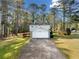 View of a two-story home and attached garage with mature trees and landscaping and long drive way at 4347 Pleasant Ridge Rd, Decatur, GA 30034