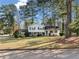 Charming two-story home featuring blue shutters and a well-maintained front yard with mature trees at 4347 Pleasant Ridge Rd, Decatur, GA 30034