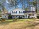 Charming two-story home featuring blue shutters and a well-maintained front yard with mature trees at 4347 Pleasant Ridge Rd, Decatur, GA 30034