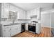 Well-lit kitchen with white cabinets, stainless steel appliances, and granite countertops at 4347 Pleasant Ridge Rd, Decatur, GA 30034