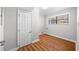 This laundry room features wood floors, a window, and a standard door at 4347 Pleasant Ridge Rd, Decatur, GA 30034