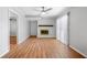 Bright living room boasts a brick fireplace, wood flooring, and a ceiling fan for added comfort at 4347 Pleasant Ridge Rd, Decatur, GA 30034
