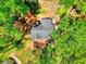 Aerial view of the house highlighting the roof, surrounded by lush green trees and ample yard space at 679 Suwanee Ct, Lawrenceville, GA 30043