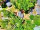 Aerial shot of the house, displaying its roof, backyard, and the surrounding lush, tree-filled neighborhood at 679 Suwanee Ct, Lawrenceville, GA 30043
