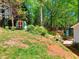 Spacious backyard with a storage shed, lush greenery, and a patio area, perfect for outdoor enjoyment at 679 Suwanee Ct, Lawrenceville, GA 30043
