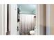 This bathroom features a shower/tub with shower curtain, and tiled flooring at 679 Suwanee Ct, Lawrenceville, GA 30043