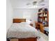 Bedroom includes ceiling fan, wooden desk, and a pink accent wall at 679 Suwanee Ct, Lawrenceville, GA 30043