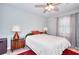Well-lit bedroom with ceiling fan, stylish lamps, and neutral paint at 679 Suwanee Ct, Lawrenceville, GA 30043