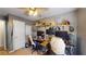 Bedroom featuring shelves, two desks, ceiling fan, and natural light at 679 Suwanee Ct, Lawrenceville, GA 30043