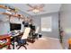 Bedroom featuring shelves, two desks, ceiling fan, and natural light at 679 Suwanee Ct, Lawrenceville, GA 30043