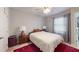 This bedroom includes a ceiling fan, window and adjacent bathroom at 679 Suwanee Ct, Lawrenceville, GA 30043
