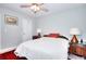 This bedroom features a ceiling fan, stylish lamps, and bright walls at 679 Suwanee Ct, Lawrenceville, GA 30043
