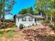 Charming one-story home features a welcoming front porch and well-maintained landscaping amidst mature trees at 679 Suwanee Ct, Lawrenceville, GA 30043