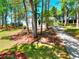 Attractive home with a well-manicured front yard, mature trees, and a long driveway at 679 Suwanee Ct, Lawrenceville, GA 30043