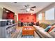 Bright living room featuring modern entertainment center and a decorative red wall at 679 Suwanee Ct, Lawrenceville, GA 30043