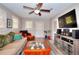 Cozy living room featuring modern ceiling fan, wood laminate flooring, and recessed lighting at 679 Suwanee Ct, Lawrenceville, GA 30043