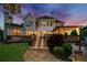 Multi-level deck with ambient lighting and a stone pathway leading to a serene backyard oasis at 903 Shaftoe Nw St, Kennesaw, GA 30152