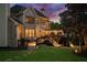 Expansive backyard featuring a deck with lights, stone walkway, and lush lawn, perfect for outdoor living and entertaining at 903 Shaftoe Nw St, Kennesaw, GA 30152