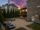 Spacious backyard featuring a brick patio, a fire pit, lounge chairs, and a pergola-covered deck for relaxing and entertaining at 903 Shaftoe Nw St, Kennesaw, GA 30152