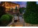 Outdoor living area featuring a covered patio, manicured landscaping, and cozy seating, ideal for relaxation and gatherings at 903 Shaftoe Nw St, Kennesaw, GA 30152