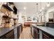 Finished basement with a custom wet bar, brick wall, and granite countertops at 903 Shaftoe Nw St, Kennesaw, GA 30152