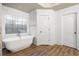 Elegant bathroom with a freestanding tub, shiplap walls, and a decorative window at 903 Shaftoe Nw St, Kennesaw, GA 30152
