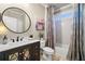 Neutral bathroom featuring a shower-tub combination, modern sink and vanity and framed mirror at 903 Shaftoe Nw St, Kennesaw, GA 30152