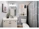 Bathroom with classic vanity, framed mirror, and cabinet for storage at 903 Shaftoe Nw St, Kennesaw, GA 30152