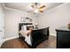 Cozy bedroom showcasing a black bed frame, neutral walls, hardwood flooring, and ample natural light at 903 Shaftoe Nw St, Kennesaw, GA 30152